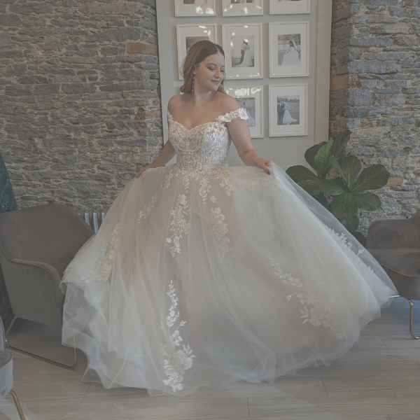 March Dress Madness wedding dress sale at Runway bridal - bride moving the skirt of her dress