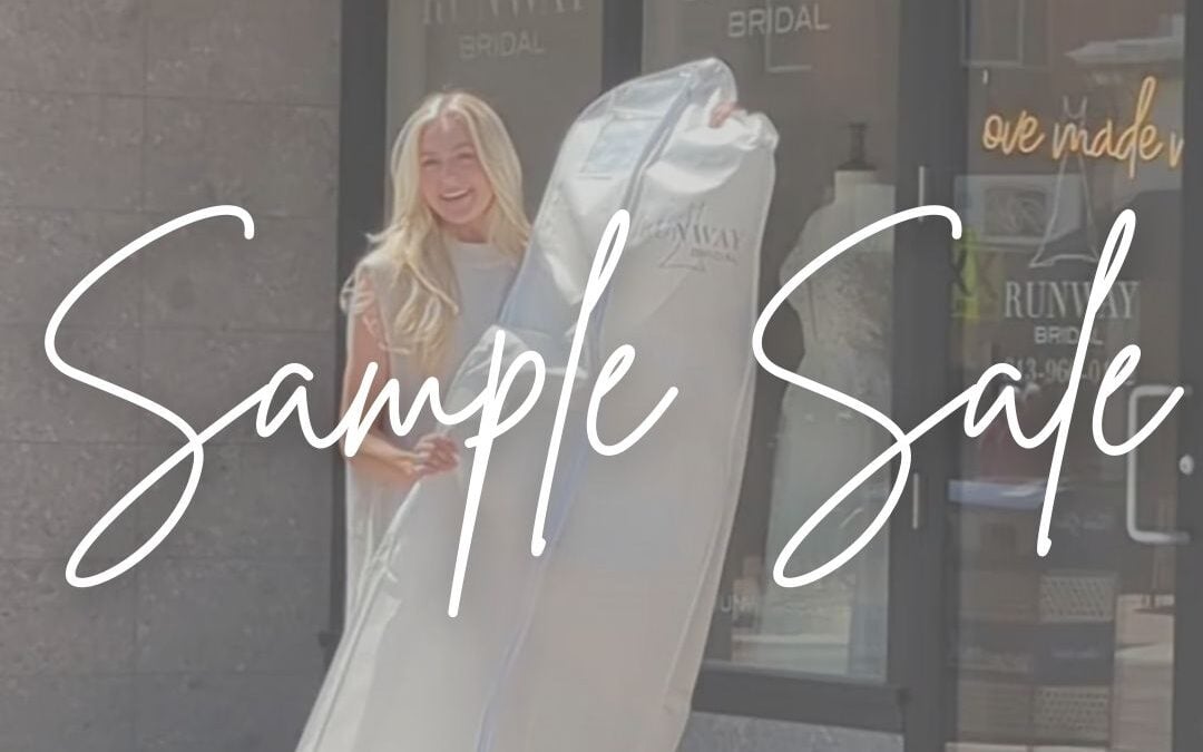 bride holding her dress in front of Runway Bridal after buying it on sale at the sample sale
