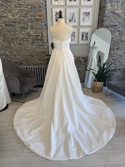 Gia a plus size aline wedding dress with a straight cuff neckline.