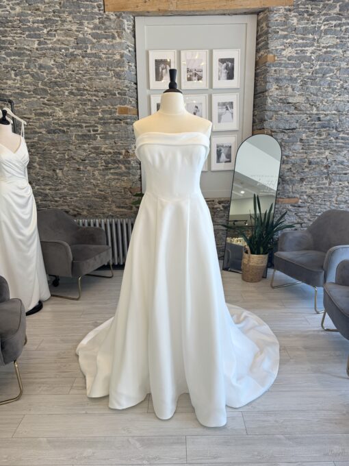 Gia a plus size aline wedding dress with a straight cuff neckline.