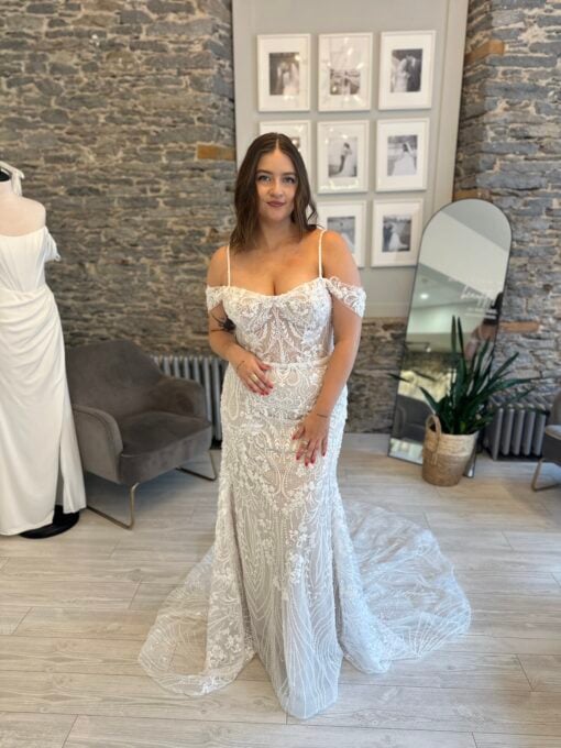 Leora a beaded sheath wedding dress with straps and off the shoulder detail.