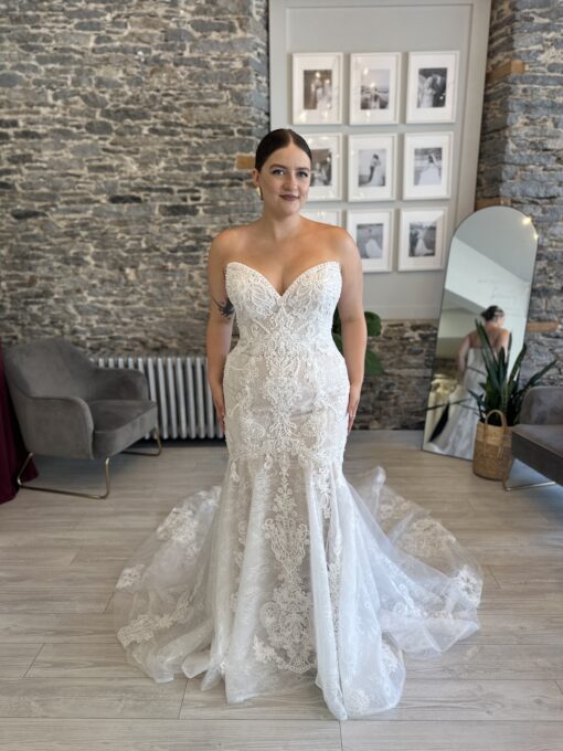Lindy, a fitted lace wedding dress with pearl details and a show stopping train.