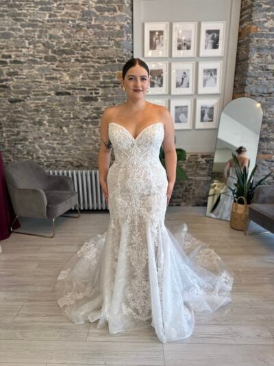 Lindy, a fitted lace wedding dress with pearl details and a show stopping train.