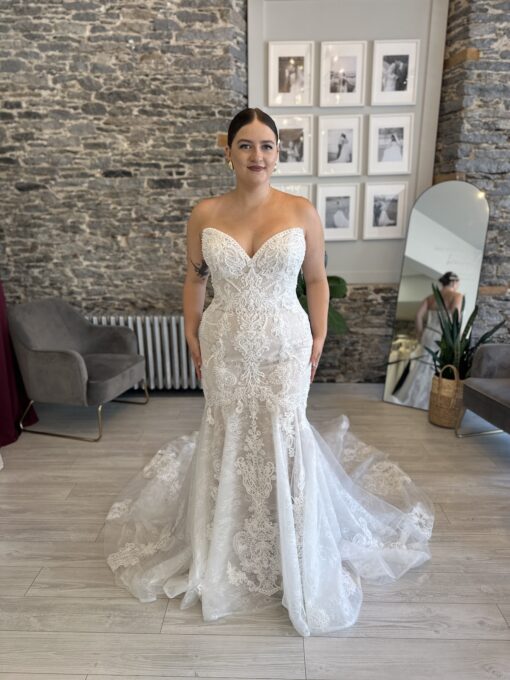 Lindy, a fitted lace wedding dress with pearl details and a show stopping train.