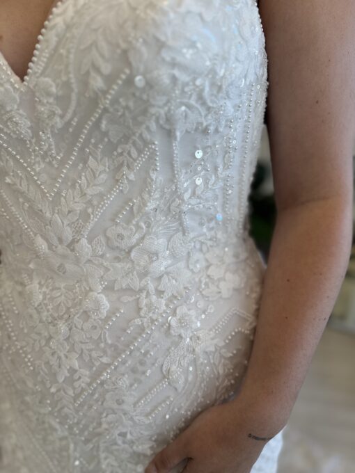 Louisa a show-stopping fitted gown dripping in sparkle and botanical lace, finished with a dramatic train.