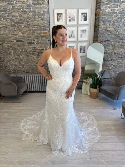 Louisa a show-stopping fitted gown dripping in sparkle and botanical lace, finished with a dramatic train.