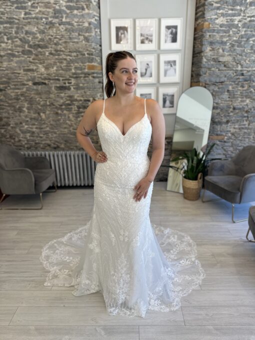 Louisa a show-stopping fitted gown dripping in sparkle and botanical lace, finished with a dramatic train.