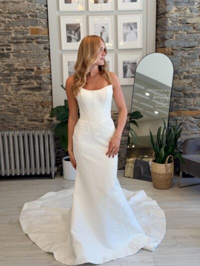 Leilani wedding dress, fitted matte satin with floral lace detail.